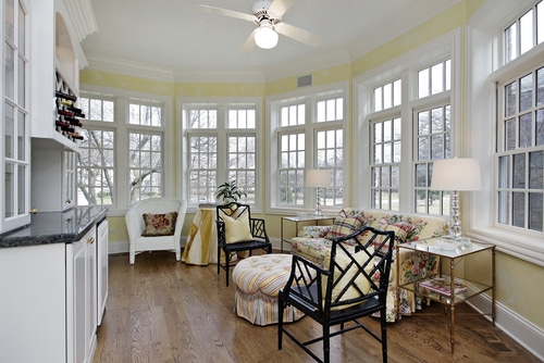 sunroom interior with yellow paint and floral decor"